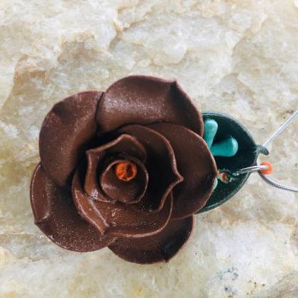 Chocolate Brown Clay Rose With Orange Center..